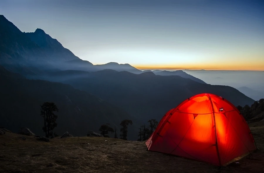 Tent glowing set up on a hill