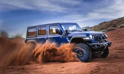 blue jeep in sand