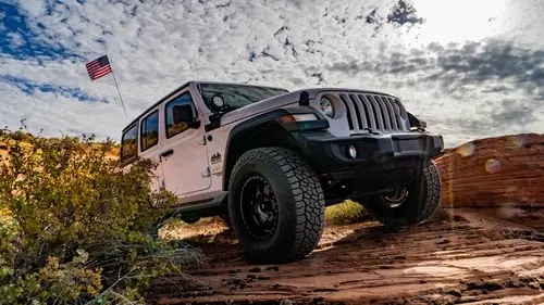 white jeep on rocks